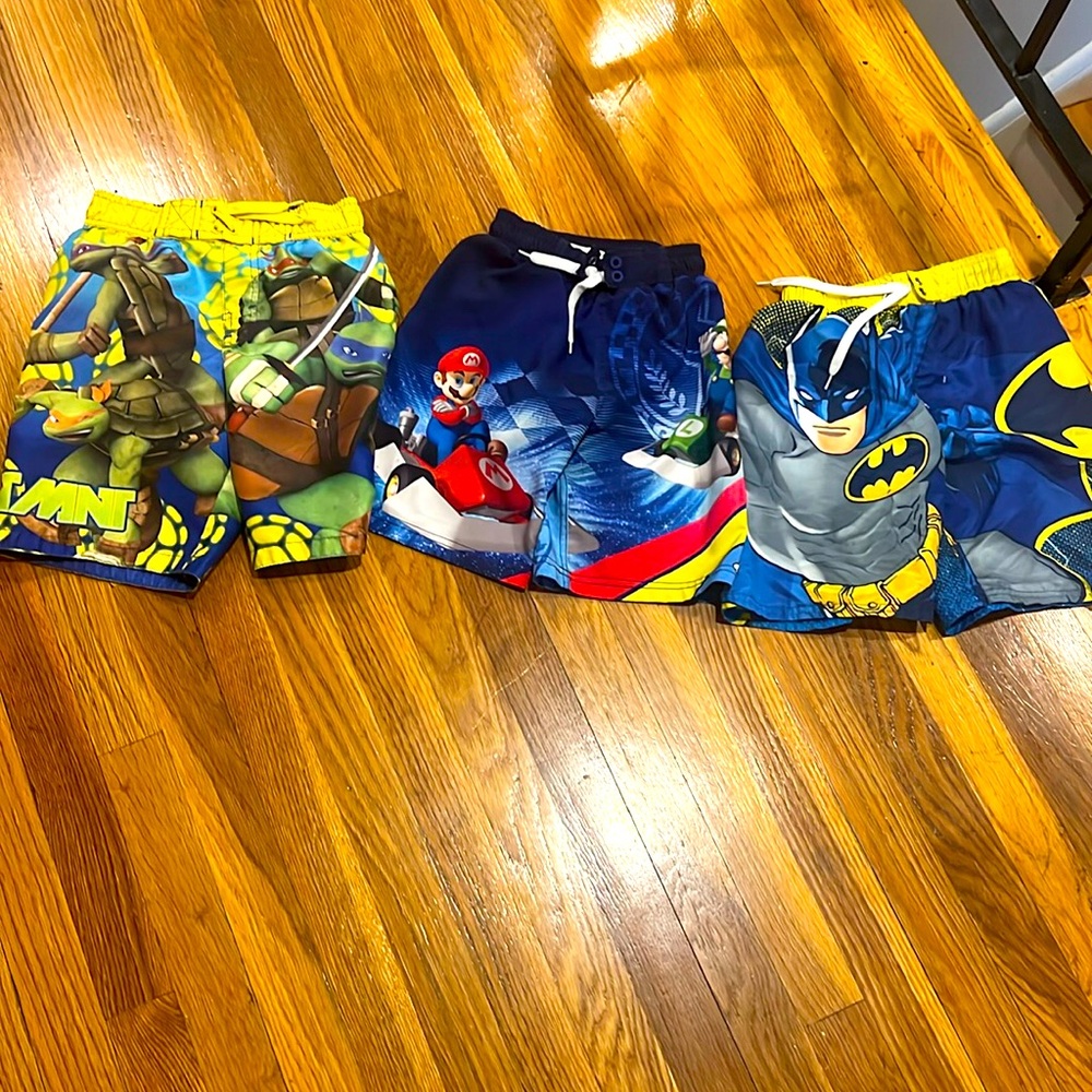 Boys swim trunks: Ninja Turtles size 8, Super Mario size 6/7, Batman size 6/7